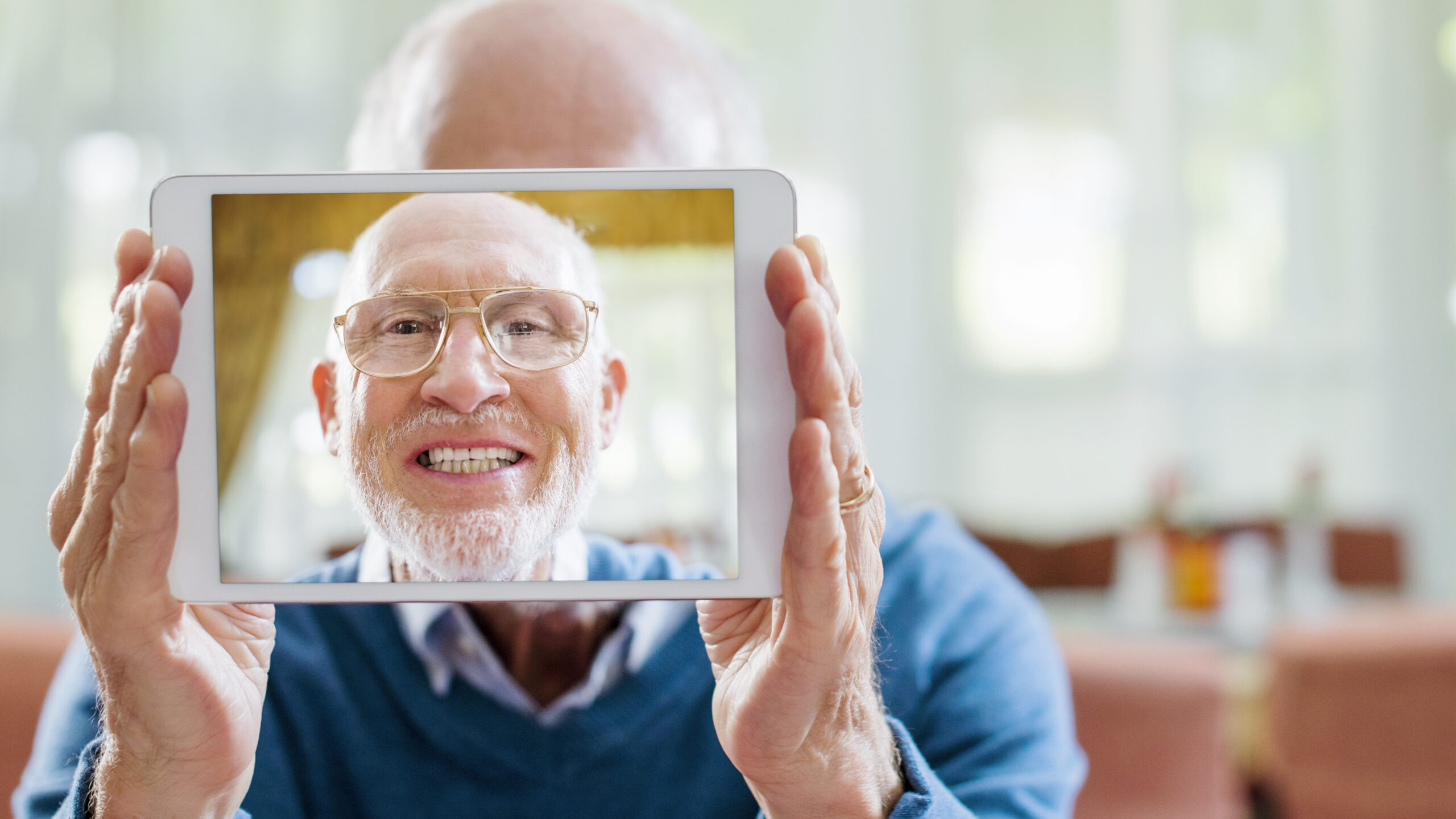 Senior man taking self portrait on digital tablet